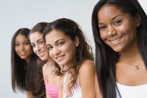 Portrait of four teen female friends smiling